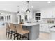 Stylish kitchen with white cabinets, quartz countertops, stainless appliances, an island with seating, and sunroom access at 7300 Wynhill Dr, Sandy Springs, GA 30328