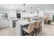 Bright kitchen boasts white cabinets, quartz countertops, stainless appliances, and a center island with seating at 7300 Wynhill Dr, Sandy Springs, GA 30328