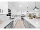 Modern kitchen featuring white cabinets, quartz countertops, stainless appliances, and a large center island at 7300 Wynhill Dr, Sandy Springs, GA 30328