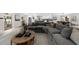Open-concept living room and kitchen space with a large sectional sofa and neutral decor at 7300 Wynhill Dr, Sandy Springs, GA 30328