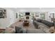 Inviting living room featuring a brick fireplace, large sectional, and bright natural light at 7300 Wynhill Dr, Sandy Springs, GA 30328