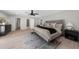 Large main bedroom with light hardwood floors, ensuite bathroom and view to back yard at 7300 Wynhill Dr, Sandy Springs, GA 30328