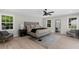 Bright main bedroom with neutral color palette, ceiling fan, and seating area next to big windows at 7300 Wynhill Dr, Sandy Springs, GA 30328