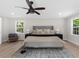 Comfortable main bedroom features seating area, neutral colors, lots of light, and ceiling fan at 7300 Wynhill Dr, Sandy Springs, GA 30328