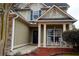 Inviting front porch with rocking chairs, stone accents, and a view of the landscaped yard at 1116 Silverbrooke Dr, Powder Springs, GA 30127