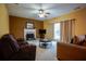 Cozy living room featuring a fireplace, ceiling fan, and ample natural light at 1116 Silverbrooke Dr, Powder Springs, GA 30127