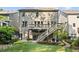 Rear of home with a spacious deck overlooking a manicured lawn and a stone-lined garden at 127 Marlow Dr, Woodstock, GA 30188