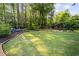 Spacious, well-manicured backyard featuring a stone border and a cozy seating area at 127 Marlow Dr, Woodstock, GA 30188