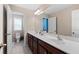 Modern bathroom with dual sinks, large mirror, and tiled floors, combining style with practicality at 127 Marlow Dr, Woodstock, GA 30188