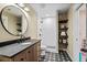 Charming bathroom featuring a round mirror, walk-in shower, and decorative tile floors at 127 Marlow Dr, Woodstock, GA 30188