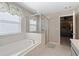 Bright bathroom features a soaking tub and glass-enclosed shower at 127 Marlow Dr, Woodstock, GA 30188