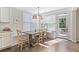Sunlit breakfast nook with built-in bench seating, wooden table, and access to the outdoor patio at 127 Marlow Dr, Woodstock, GA 30188