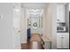 Elegant hallway featuring hardwood floors, floral wallpaper, and access to the front door at 127 Marlow Dr, Woodstock, GA 30188