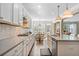 Bright kitchen with white cabinets, stainless steel appliances, countertop seating, and an adjacent breakfast nook at 127 Marlow Dr, Woodstock, GA 30188