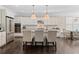 Bright, modern kitchen with white cabinets, stainless steel appliances, large island with seating, and hardwood floors at 127 Marlow Dr, Woodstock, GA 30188
