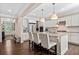 Beautiful kitchen featuring white cabinetry, a large center island, and stainless-steel appliances with hardwood floors at 127 Marlow Dr, Woodstock, GA 30188