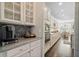 Kitchen featuring white cabinets, stainless steel appliances, tile backsplash, and an open layout to the breakfast nook at 127 Marlow Dr, Woodstock, GA 30188