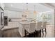 Bright kitchen with stainless steel appliances, white cabinetry, island seating, and an adjacent breakfast nook at 127 Marlow Dr, Woodstock, GA 30188