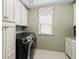 Efficient laundry room featuring modern appliances and ample cabinet space, designed for easy chore management at 127 Marlow Dr, Woodstock, GA 30188