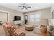Comfortable living room with a sofa, two chairs, neutral walls, and a large window at 127 Marlow Dr, Woodstock, GA 30188