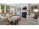 Cozy living room with fireplace, large windows, neutral color palette, and comfortable seating arrangement at 127 Marlow Dr, Woodstock, GA 30188