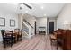 Bright living area featuring wood floors, a piano, a staircase, and stylish furniture at 127 Marlow Dr, Woodstock, GA 30188