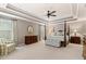 Large main bedroom with tray ceiling, sitting area, and four-poster bed at 127 Marlow Dr, Woodstock, GA 30188