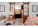 View of the modern pantry through sliding barn doors from the living room at 127 Marlow Dr, Woodstock, GA 30188