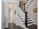 Elegant staircase featuring dark wood steps, white risers, and modern décor at 127 Marlow Dr, Woodstock, GA 30188