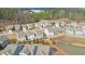 Aerial view of a neighborhood, showcasing a variety of houses and a serene pond at 137 Centennial Ridge Dr, Acworth, GA 30102