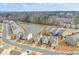 Aerial view of a community with a pond, showcasing the neighborhood layout and surrounding greenery at 137 Centennial Ridge Dr, Acworth, GA 30102
