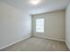 A well-lit bedroom offers a serene atmosphere with a neutral color scheme and plush carpeting at 137 Centennial Ridge Dr, Acworth, GA 30102