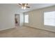Spacious bedroom with neutral carpet, two windows, and access to a walk-in closet at 137 Centennial Ridge Dr, Acworth, GA 30102