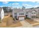 Charming two-story home features a brick-accented garage, neutral siding and a well-manicured lawn at 137 Centennial Ridge Dr, Acworth, GA 30102