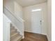 Bright foyer showcasing hardwood floors, a staircase, and a white front door with sidelight at 137 Centennial Ridge Dr, Acworth, GA 30102