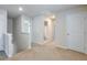 Hallway with neutral carpet, white trim, and a view into a bathroom at 137 Centennial Ridge Dr, Acworth, GA 30102