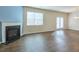 Spacious living room with a fireplace, large window, and sleek hardwood floors at 137 Centennial Ridge Dr, Acworth, GA 30102