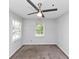 Bright bedroom with neutral carpet, ceiling fan, and two windows for ample natural light at 1432 Forest Villa Dr, Conyers, GA 30012