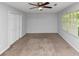 Bedroom features neutral carpet, a ceiling fan, and two large closets for plenty of storage at 1432 Forest Villa Dr, Conyers, GA 30012