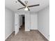 A bedroom has a ceiling fan, carpet, and two doors inside for extra functionality at 1432 Forest Villa Dr, Conyers, GA 30012