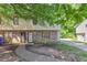Inviting townhouse with a brick facade, covered entry, and mature trees at 1432 Forest Villa Dr, Conyers, GA 30012