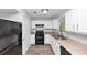 Functional kitchen with black appliances, white cabinets, and lots of counter space at 1432 Forest Villa Dr, Conyers, GA 30012