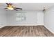 Bright living room featuring hardwood floors, a ceiling fan, and a window at 1432 Forest Villa Dr, Conyers, GA 30012