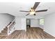 Open-concept living room featuring hardwood floors, a staircase, and natural light at 1432 Forest Villa Dr, Conyers, GA 30012
