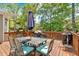 Outdoor deck with seating and grilling area, surrounded by lush greenery at 3921 Upland Way, Marietta, GA 30066