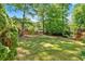 Large, grassy backyard with a hammock, enclosed by a wooden fence, creating a private outdoor space at 3921 Upland Way, Marietta, GA 30066