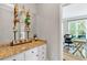 Bar area with granite counters, and glass shelves, open to an office space at 3921 Upland Way, Marietta, GA 30066