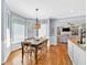Sunlit dining area with a modern chandelier and views into the living room at 3921 Upland Way, Marietta, GA 30066