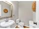 Charming powder room with pedestal sink, toilet, and neutral decor at 3921 Upland Way, Marietta, GA 30066
