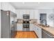 Modern kitchen with stainless steel appliances, granite countertops, and white cabinetry at 3921 Upland Way, Marietta, GA 30066